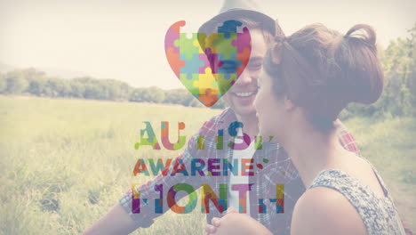 sitting in field, couple with autism awareness puzzle heart animation overlay