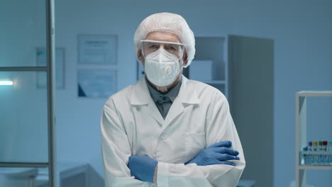 senior male scientist in protective uniform posing in lab