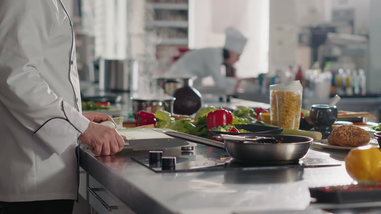 Male cook preparing garlic to add to aromatic food recipe