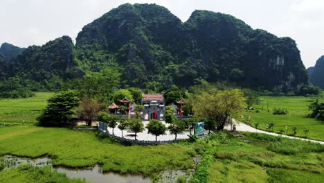 drone approaching thai vi temple in ninh binh, vietnam at low altitude on a sunny day