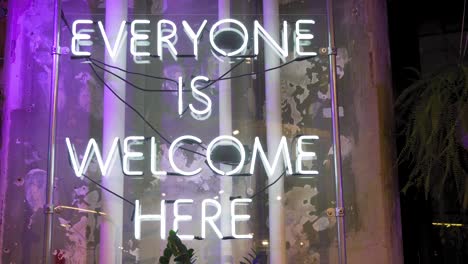 everyone is welcome here vintage neon electric sign in new york usa, close up