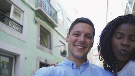 happy multiracial couple posing for self portrait outdoor.