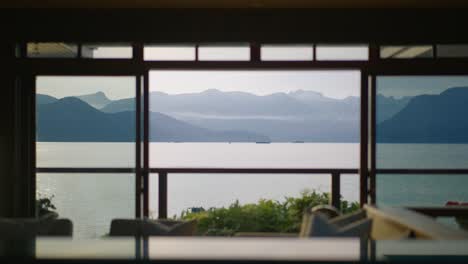 a scenic shot of scenic views of the sea and the mountains of bowen island from inside a luxury property in lions bay, british columbia, canada