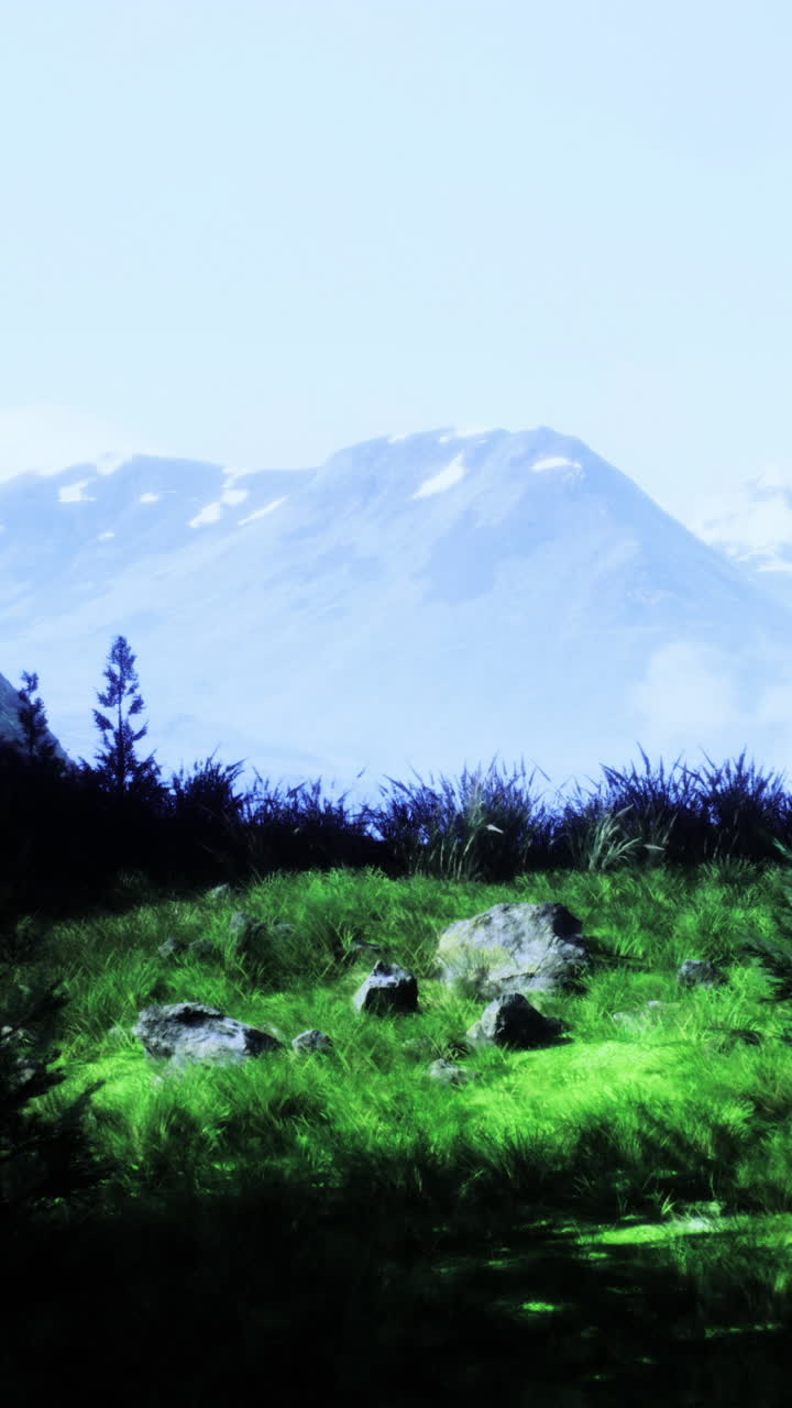 Majestic mountain landscape with vibrant green fields and distant peaks