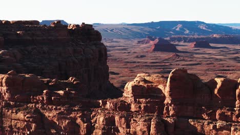 Drone-dolly-move-with-foreground-rocks-and-a-beautiful-Utah-desert-in-the-background-at-magic-hour