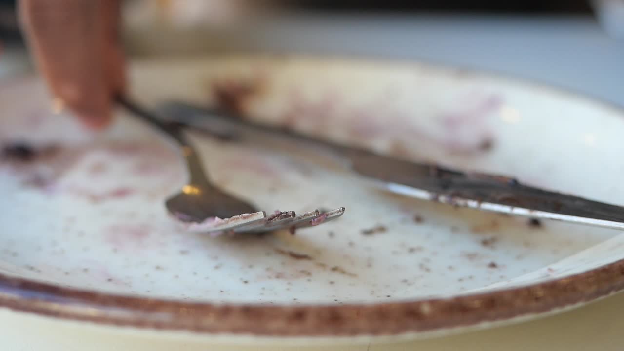 Leerer Teller mit Gabel und Messer nach einer Mahlzeit