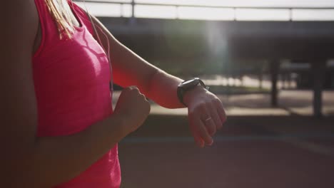 woman looking at her watch in a park