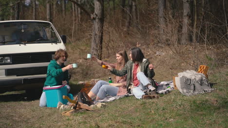 Two-Young-Girls-And-A-Young-Boy-Have-A-Good-Time-In-The-Forest-Having-A-Hot-Beverage-1