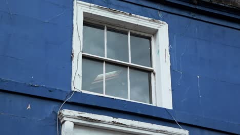 traditional british window style of blue house in notting hill