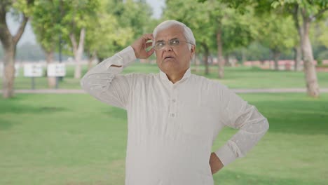 Confused-Indian-old-man-thinking-in-park