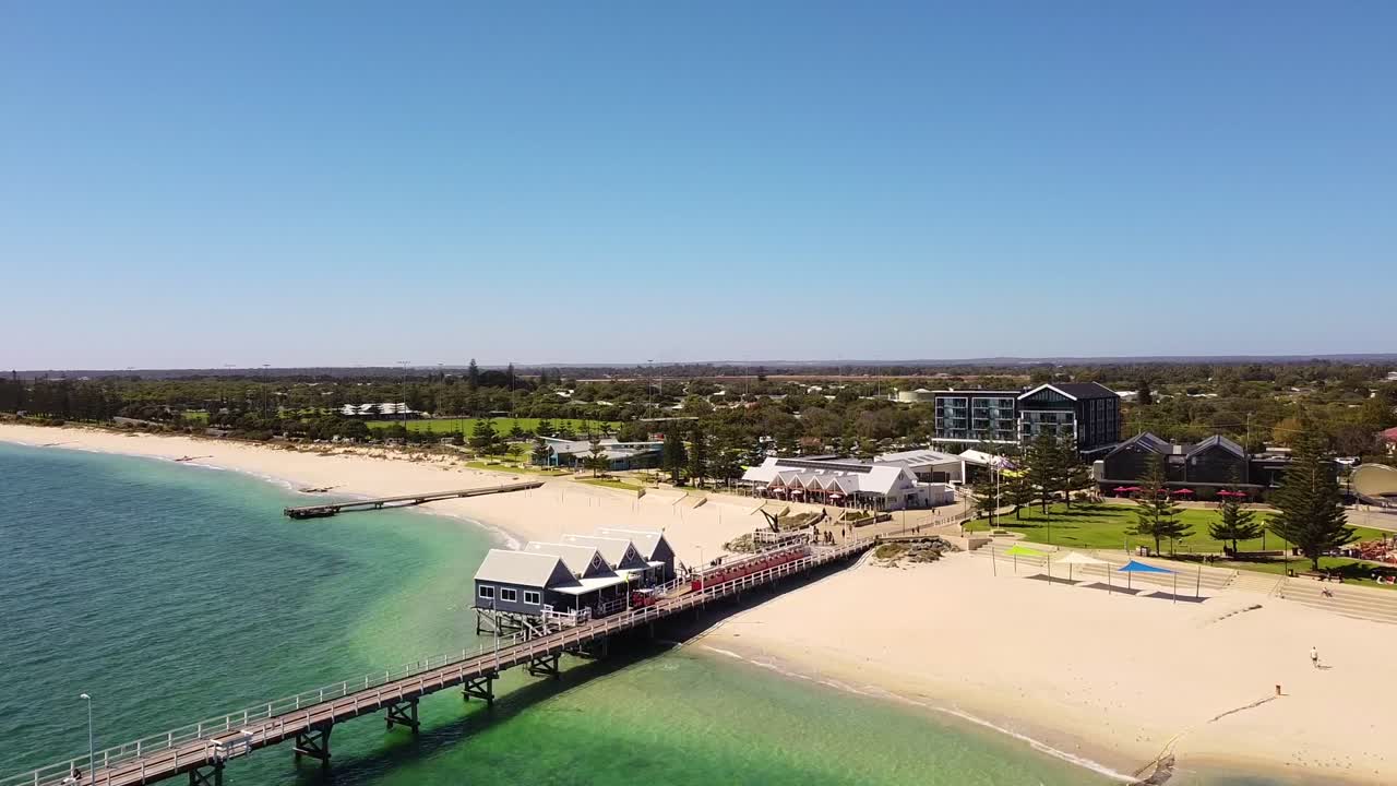 Aerial View of a Beautiful Beach with a Pier and Hotel