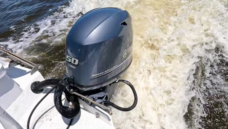 outboard motor powering through ocean waves