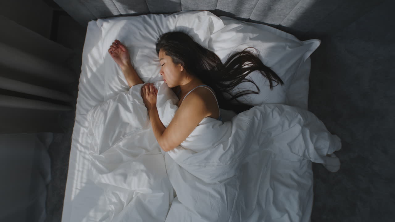 Woman Sleeping Peacefully in Bed