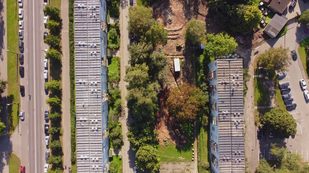 Aerial view of residential buildings and construction site along major road
