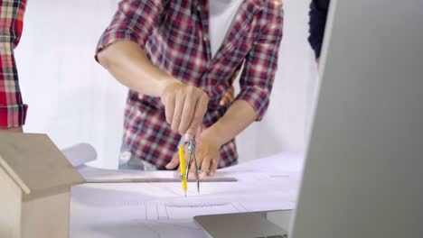 architect engineer drawing of circle line on paperwork for design blueprint of the village project and real estate building