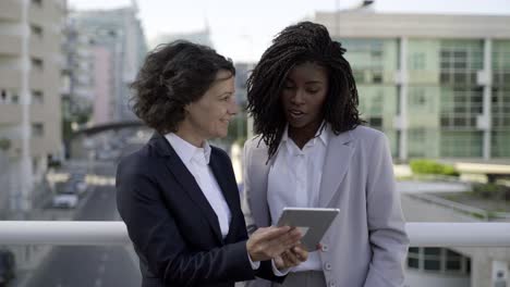 Businesswomen-using-digital-tablet-outdoor