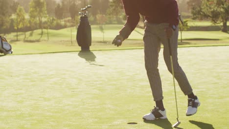 Video-of-legs-of-african-american-man-playing-golf-on-golf-field