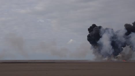 explosion on a beach black smoke uk 4k