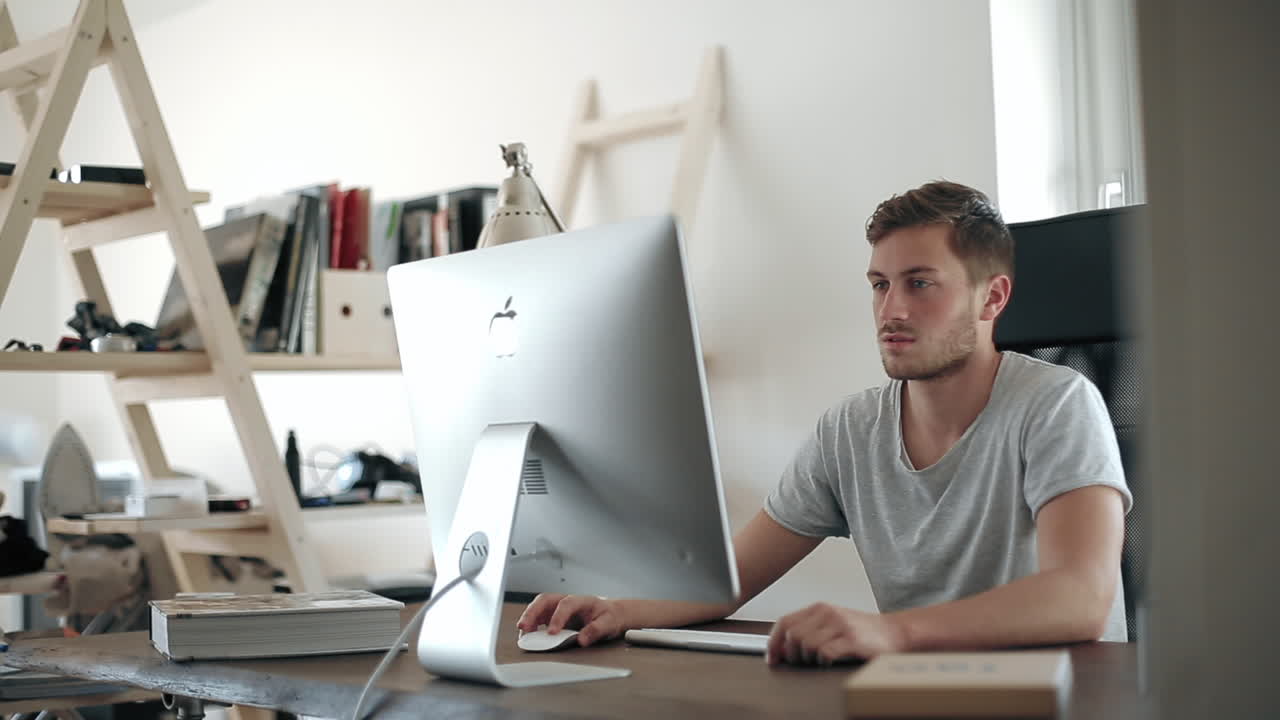 Man working on a computer in a home office