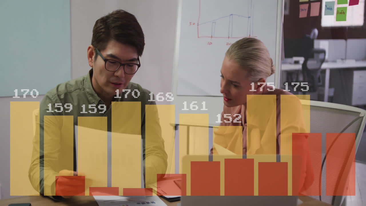 Discussing data, two colleagues using bar chart animation in office setting