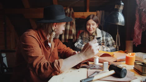 craftsman smoking as his wife drinking tea in workshop