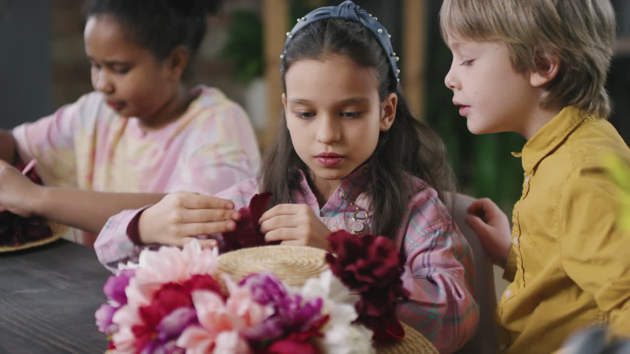 Children Putting Flowers on Straw Hats