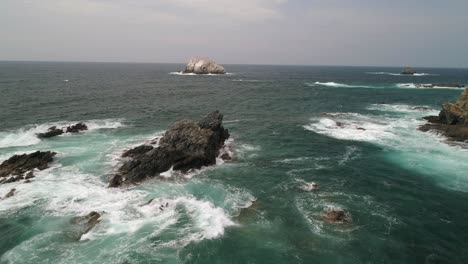 Aerial-shot-of-the-rocks-formations-of-Zipolite-beach-Oaxaca