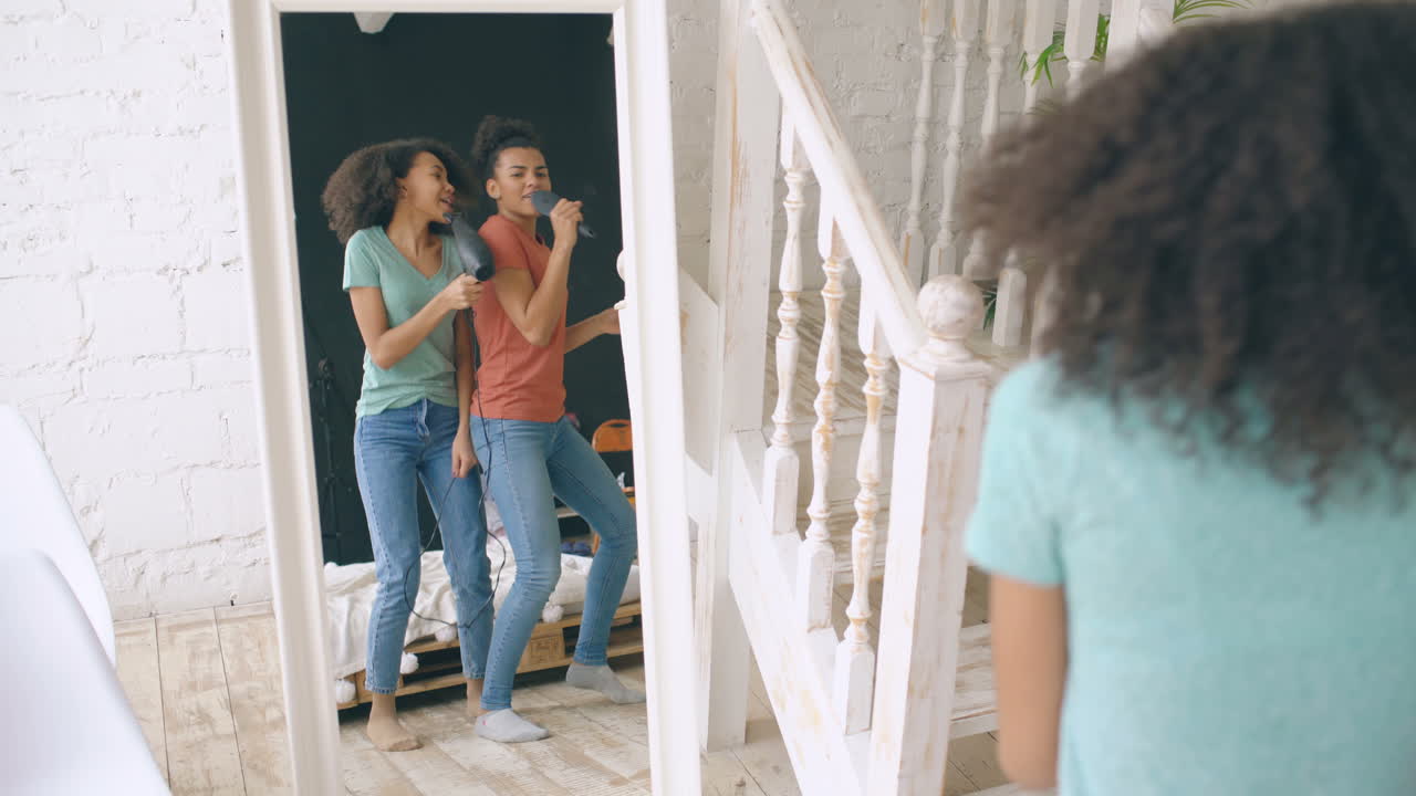 Sisters Singing and Dancing in Front of a Mirror