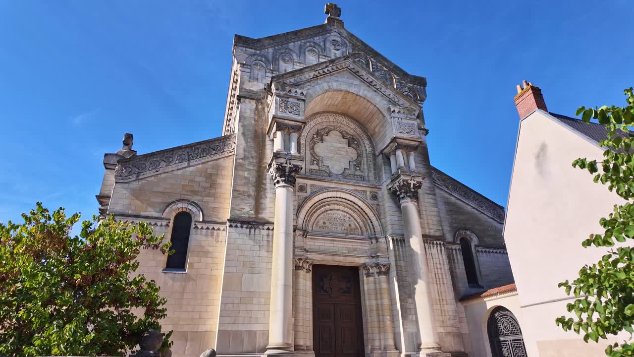 Exterior entrance view and facade of Basilica of Saint Martin in sunny day, Tours, France
