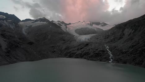 Aerial-view-of-the-Gauli-glacier-and-lake-in-the-Bernese-Oberland-region-of-the-Swiss-Alps-at-the-end-of-a-cloudy-day