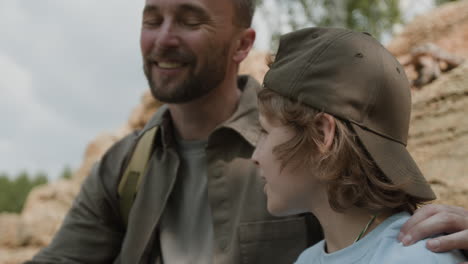 father and son exploring nature with binoculars
