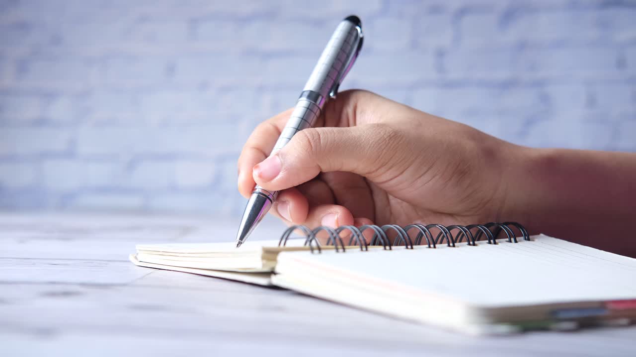 Hand writing in a spiral notebook