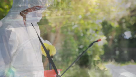 animation of man wearing face mask, spraying disinfectants over people on street.