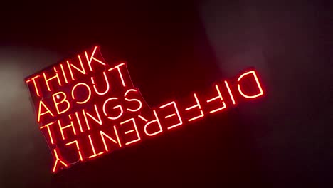 neon sign with 'think about things differently' quote