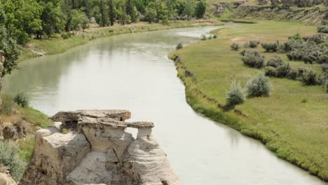 Establishing-shot:-River-valley-rock-hoodoos-and-green-summer-meadow