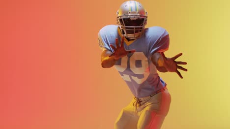 Video-of-african-american-american-football-player-over-yellow-to-orange-background