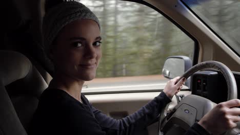 Young-pretty-woman-driving-vintage-ford-van-in-the-pacific-northwest