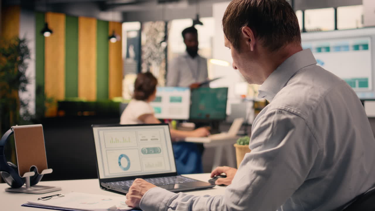 Corporate lifestyle scene with man reviewing KPI metrics and data analysis