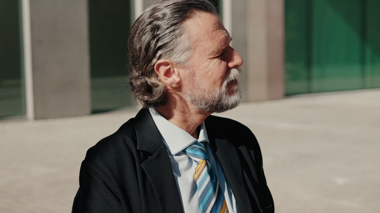 Businessman Enjoys Sunshine Outside Office Building