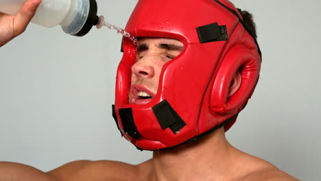 tough boxer pouring water over his face