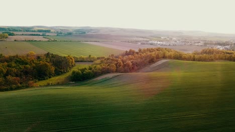 stunning aerial view of rolling green hills and farmland at sunset
