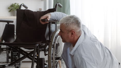 man struggling with wheelchair