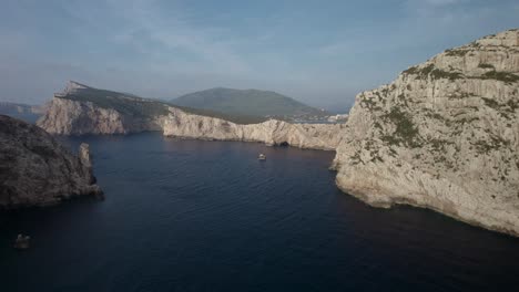 Aerial-approach-shot-to-the-cliffs-of-Capo-Coccia,-Sardinia,-Italy