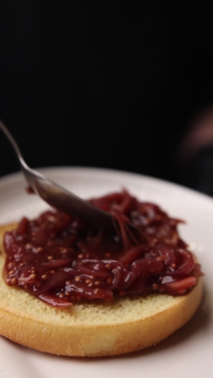 Spreading Red Onion Marmalade on a Toasted Burger Bun