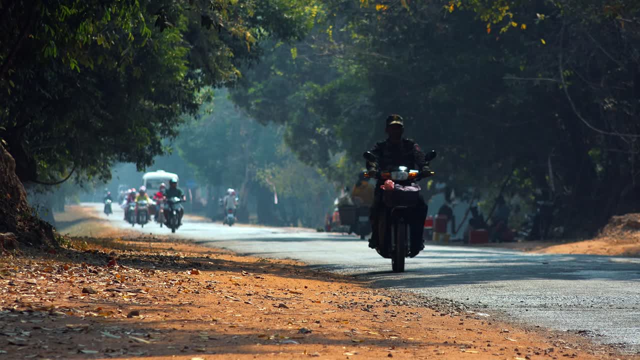 Time lapse of Busy Countryside Road With Tress on Each Side and Small Roadside Stalls