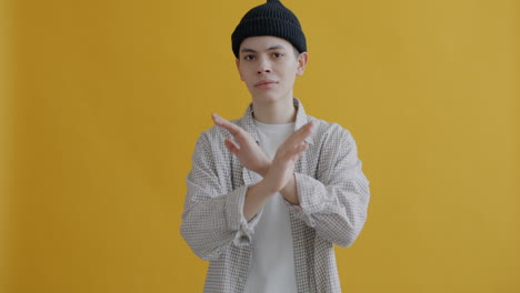 teenager rejecting gesture against yellow background