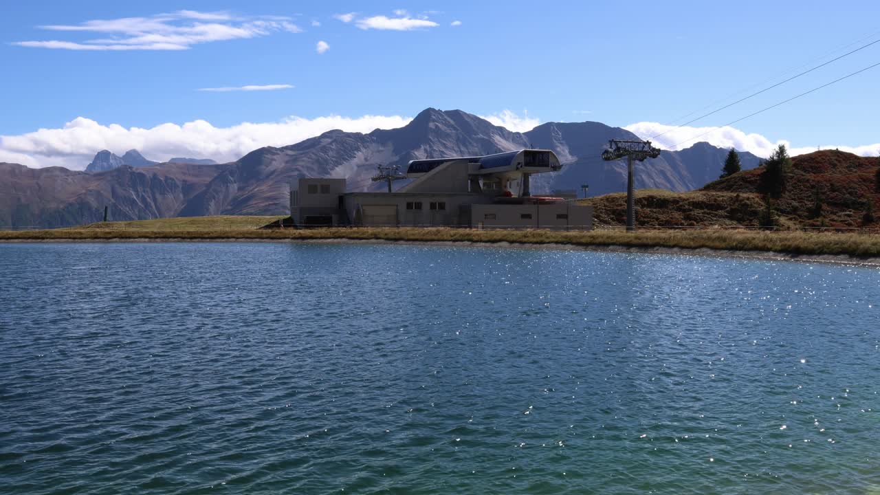 Ski lift by a mountain lake in the summer, Aletsch arena Switzerland
