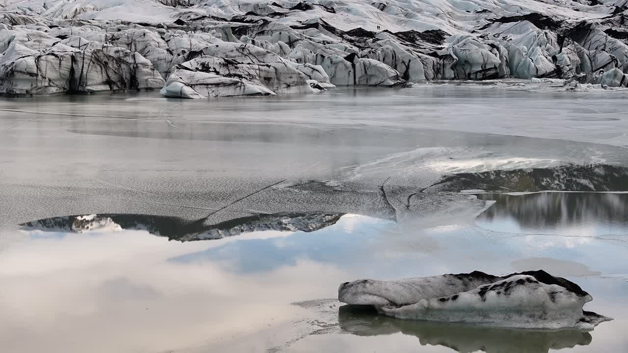 Glacial lagoon with icebergs at Sólheimajökull, part of Mýrdalsjökull Glacier in Iceland. Cold wilderness, frozen textures, volcanic ash blending with pristine ice.