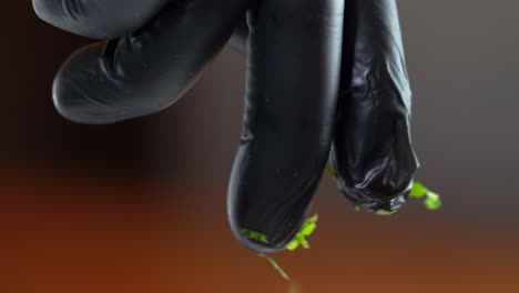 macro-shot-dressing-with-cilantro-coriander-chef-using-grill-gloves