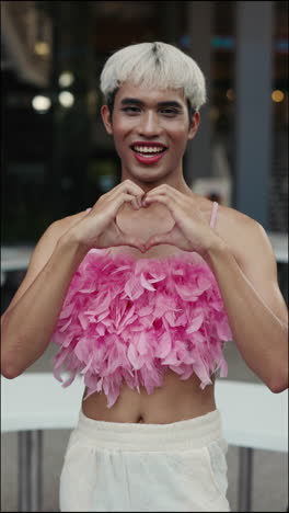 Smiling Man Posing Outdoors in Pink Feather Top